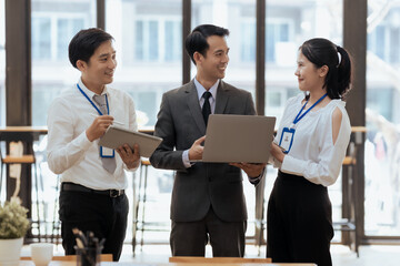 Group of young asian business people collaborate and discuss business plan during team meeting in...