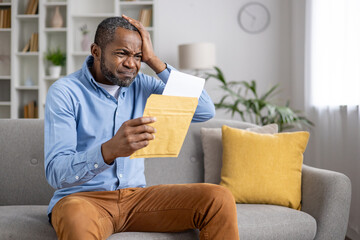 Senior gray haired man upset received envelope mail message notification with bad news, sad...