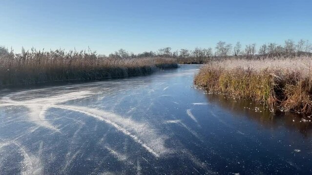 Point of View ice skating in the Weerribben Wieden nature reserve in The Netherlands during a beautiful winter day