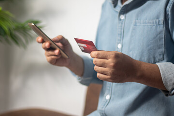 Obraz na płótnie Canvas Businessman uses credit card to shop online, pay