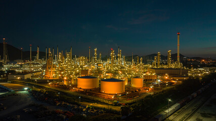 Aerial view of the morning of the oil refinery from the drone of the tower of the Petrochemistry industry in the oil​ and​ gas​ ​industry with​ cloud​ sun orange​