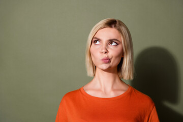 Photo portrait of attractive young woman look skeptical empty space wear trendy orange clothes...