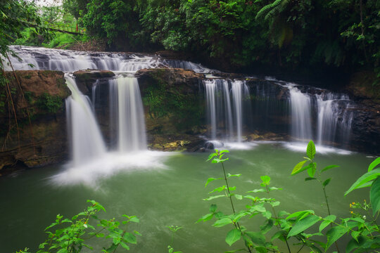 panoramic view of Indonesia with morning sun and waterfall in tropical forest