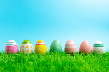 Colorful Easter eggs on green grass. Spring holidays concept.