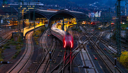 Main station wide angle panorama with tracks, platforms, signals and light traces of passing...