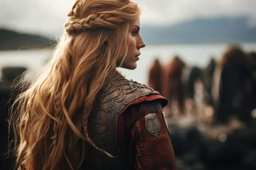 Foto op Plexiglas A Viking stands poised and resolute on the battlefield, her intricate braids and battle-worn armor embodying the fierce spirit of the legendary female warriors of Norse mythology © ChaoticMind