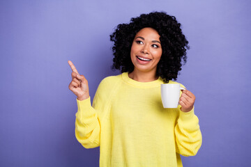 Photo of nice woman with afro hair dressed yellow sweater hold cup of tea indicating look empty...