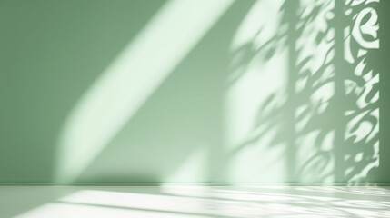 Minimalistic abstract gentle light green background for product presentation with light andand intricate shadow from the window on wall.