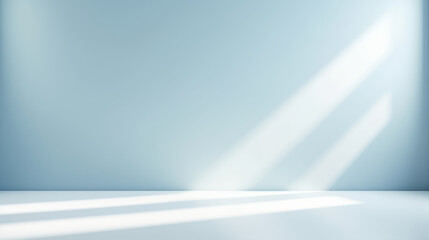 Minimal abstract light blue background for product presentation. Shadow and light from windows on plaster wall.