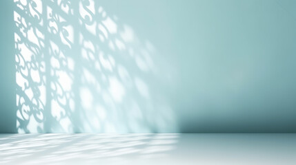 Minimalistic abstract gentle light blue background for product presentation with light andand intricate shadow from the window on wall.