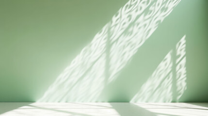 Minimalistic abstract gentle light green background for product presentation with light andand intricate shadow from the window on wall.