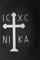 Cross. Detail of St Michael monastery metal gate in  Old Jaffa, Tel Aviv-Yafo, Israel. Letters IC XC NIKA meaning "Jesus Christ conquers". Black white historic photo.