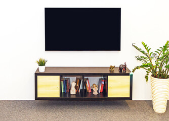 Large TV screen above wooden cabinet