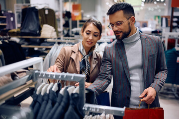 Young couple enjoying in shopping clothes at store.