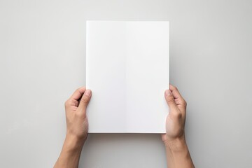 A professional presentation with hands holding a blank sheet of paper on a white background. - obrazy, fototapety, plakaty