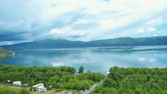  Aerial view Sevan lake with trees and mountains background. Drone fly over Sevan lake in Armenia, Caucasus.