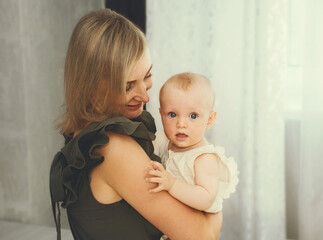 young mother holding a baby in her arms