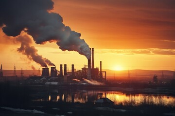 Sunrise over Industrial Metallurgical Plant with Smoke Emitting from Pipes