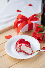 heart shaped glazed valentine cake and flowers on wooden tray
