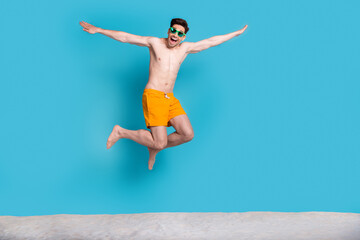 Full length photo of nice young male jump fly hands plane dressed stylish yellow shorts isolated on...