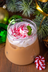 Iced Peppermint Mocha or Latte, Christmas coffee drink with crushed candy canes, whipped cream and mint syrup, festive holiday cold drink 