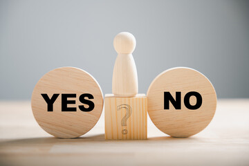 Wooden block choice showcases people's conflict between right and wrong contemplating yes or no...