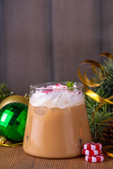 Iced Peppermint Mocha or Latte, Christmas coffee drink with crushed candy canes, whipped cream and mint syrup, festive holiday cold drink 