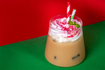 Iced Peppermint Mocha or Latte, Christmas coffee drink with crushed candy canes, whipped cream and mint syrup, festive holiday cold drink 