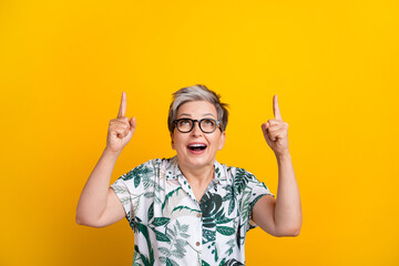 Photo portrait of nice pensioner lady point look up empty space wear trendy tropical print outfit...