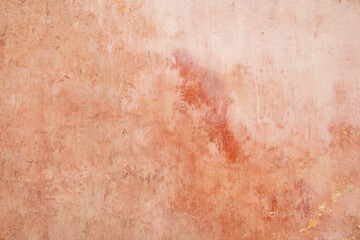 Texture of old rustic wall covered with pink stucco. Abstract background for design.