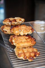 Eating of fresh baked hot Belgian sugar waffles, street food in Bruges