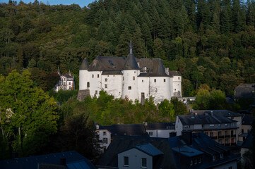 Fototapeta na wymiar Views of Clervaux commune with town status in northern Luxembourg, capital of canton of Clervaux, white castle on sunset