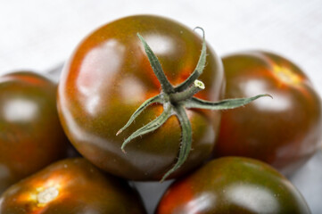 Fresh ripe sweet reddish brown and green kumato tomatoes