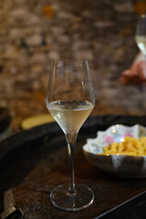 Tasting of grand cru sparkling white wine with bubbles champagne by old champagne caves in grand cru wine producer small village Cramant, Champagne, France