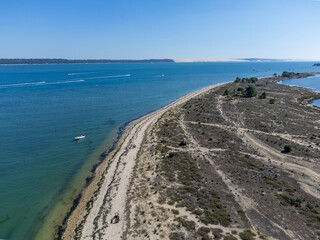 Aerial view on Arcachon Bay with many fisherman's boats and oysters farms near Le Phare du Cap...
