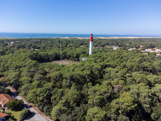 Aerial view on Arcachon Bay with many fisherman's boats and oysters farms and red lighthouse Le...