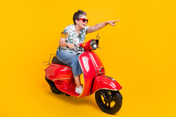 Full length photo of lovely grandma scooter point forward direction wear trendy tropical print garment isolated on yellow color background
