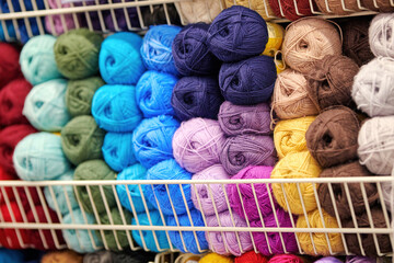 Wool and yarn ball, knitting shop. Shelf with multicolored cotton balls of yarn, multicolored...