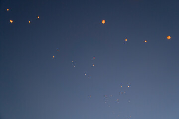 Thai people release sky floating lanterns or lamp to worship Buddha's relics at night. Traditional...