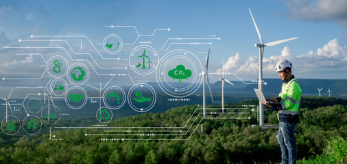 Engineers are using notebooks to analyze energy from electric wind turbines to reduce pollution, green technology. caring for the environment and sustainable development signs with icons