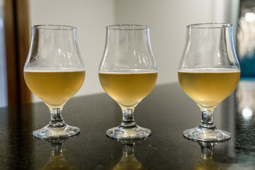 Closeup of Three beer glasses with reflection in the kitchen. Drinking concept.