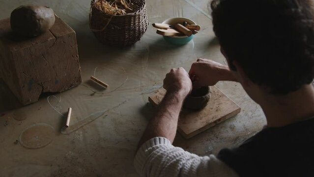 Embark on a captivating journey into the world of a skilled Latino artisan, where the hands of creativity mold and shape clay into a unique masterpiece. 