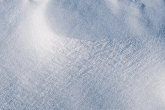 Smooth snow background, top view. Snow texture for publication, poster, screensaver, wallpaper, postcard, banner, cover, post. Winter backdrop. High quality photography