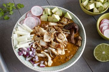 Vegan Pozole topped with fresh vegetable ingredients. Mexican cuisine homemade food with jackfruit instead of meat...