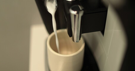 The process of making coffee. Close up of a coffee maker making coffee in a white cup. I pour the...