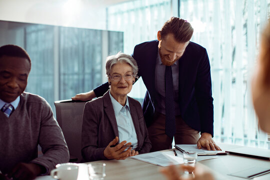 Diverse company employees having team meeting in conference room