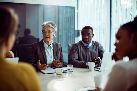 Diverse company employees having team meeting in conference room