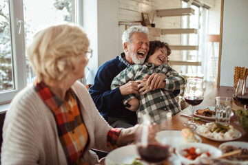 Happy grandparents having fun with grandson at home