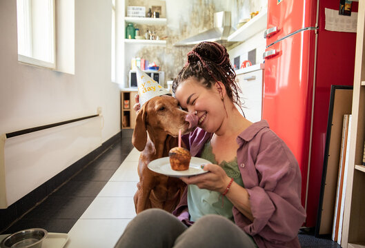 Woman having birthday celebration for dog at home