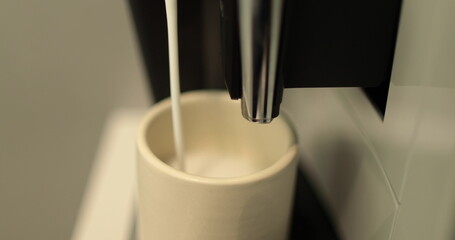 The process of making coffee. Close up of a coffee maker making coffee in a white cup. I pour the...